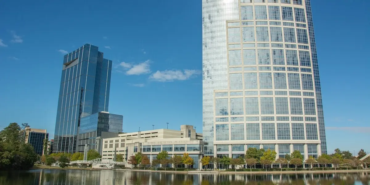 Modern glass office towers and commercial buildings along The Woodlands Waterway in Montgomery County, Texas